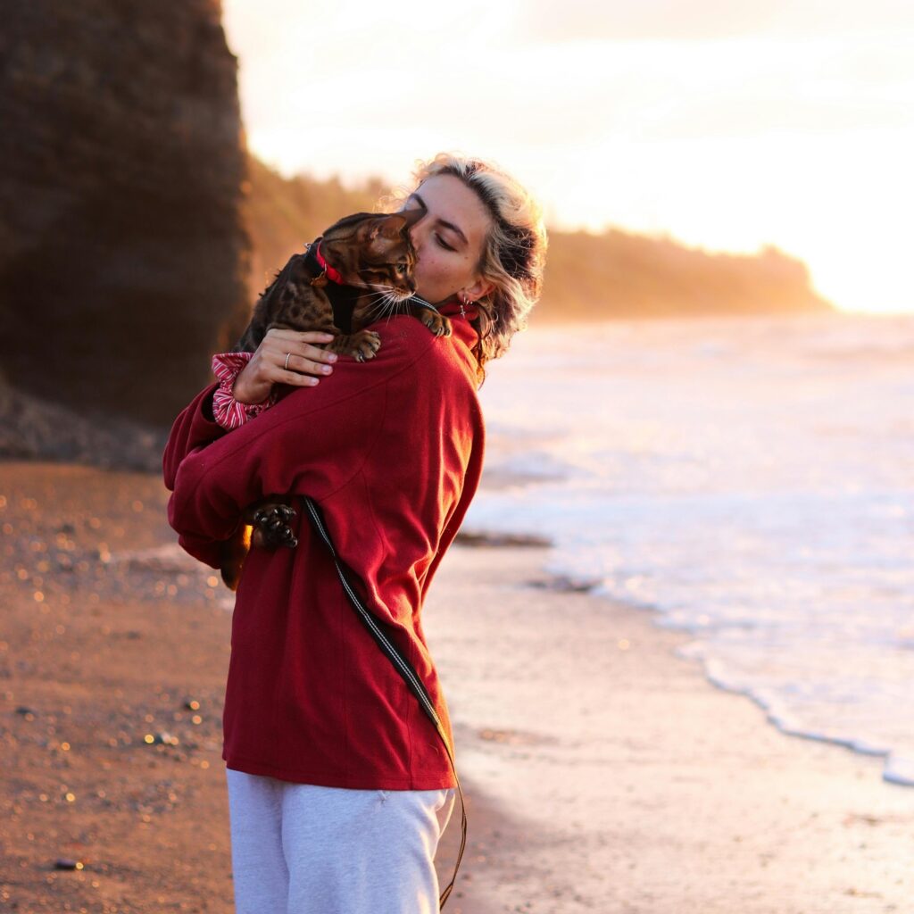 Woman Holding A Cat At The Beach